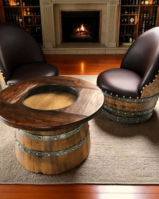 Barrel lounge chairs and a round Wine Barrel table by a lit fireplace