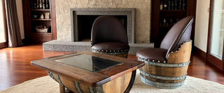 Wine Barrel lounge chairs and glass-top barrel coffee table by a stone fireplace
