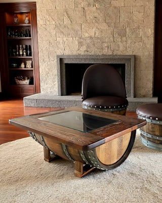 Wine Barrel lounge chairs and glass-top barrel coffee table by a stone fireplace